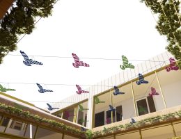 Artist's impression of a sculpture of birds above a courtyard. View from below.